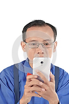 Nerdy man holding cellphone and look concentration