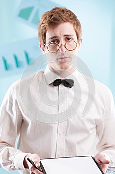 Nerdy man in outdated office suit, saddened and deluded