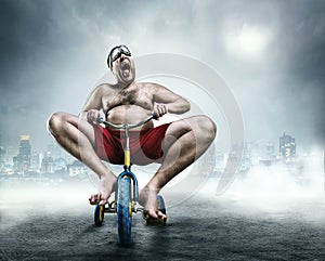 Nerdy man riding a small bicycle