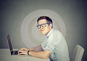 Nerdy man using a laptop computer