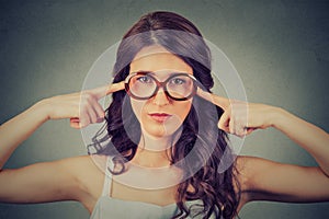 Nerdy woman in glasses plugging ears with fingers doesn't want to listen