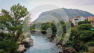 The Neretva River flowing through Mostar, with Hum Hill and Christain Cross