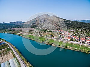 Neretva River and Valley Landscape with Green Hills and Village photo