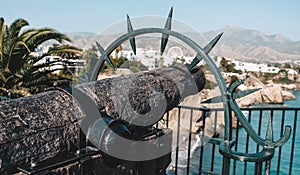 Nerja / Spain - October 2019: Close up view of a carved heavy old Spanish cannon at famous viewpoint Balcon de Europa. Popular