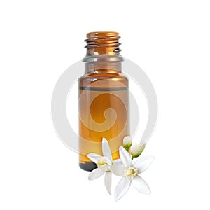 Neroli essential oil and flowers isolated on white