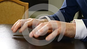 Nerveous male fingers. Adult man hand finger tapping on table. Waiting for someone or something. Modern life challanges