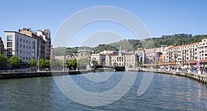 Nervion river in the center of Bilbao, with the town hall in the background in the Basque Country