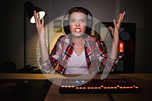 Nervous angry young woman gamer playing