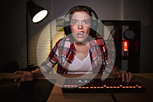 Nervous angry young woman gamer playing