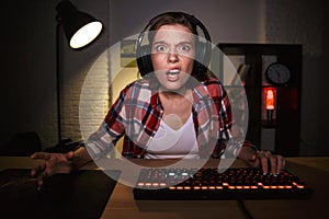 Nervous angry young woman gamer playing photo