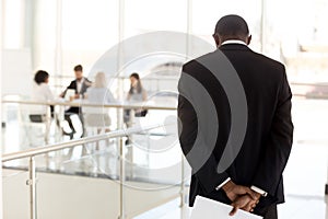 Nervous black employee waiting in hallway before entering meetin