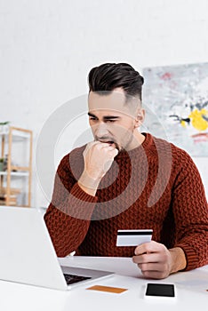 nervous bookmaker biting fist while holding