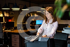 Nervous breakdown at work. Business woman freaks out and breaks the computer in the office