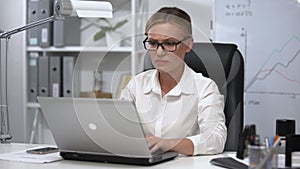 Nervous business woman freaking out working on laptop, stressful job, deadline