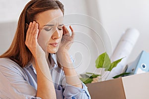 Nervous emotional woman having a headache after being dismissed