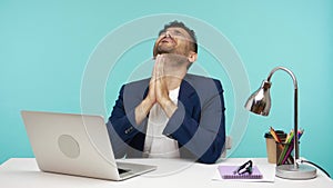 Nervous frustrated business man pressing hands in pray, asking god to help him, begging about success in work