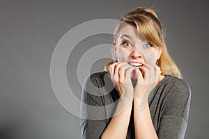 Nervous girl biting nails.