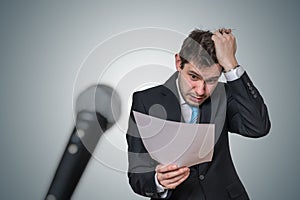 Nervous man is afraid of public speech and sweating. Microphone in front