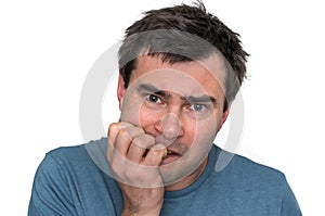 Nervous man biting his nails isolated on white