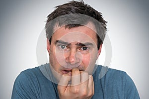 Nervous man biting his nails - nervous breakdown