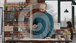 Nervous man checking time on watch and waiting important call