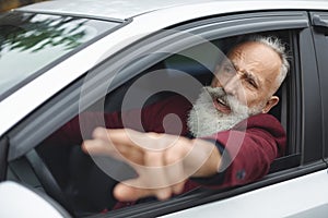 Nervous man driver fighting on the road, stuck in traffic