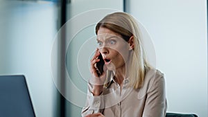 Nervous manager shouting smartphone at work closeup. Furious woman arguing call