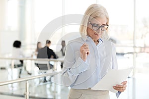 Nervous middle-aged businesswoman feeling stressed afraid waitin photo