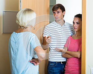 Nervous neighbors coming to old lady with complains photo