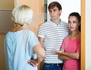 Nervous neighbors coming to old lady with complains photo
