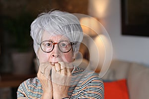 Nervous senior woman bitting nails