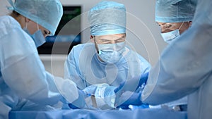 Nervous surgeons performing operation in hospital with modern equipment, work