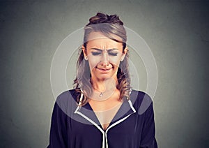 Nervous woman looking off and annoyed squinting eyes in frustration