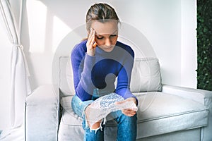 Nervous woman popping bubbles in bubble wrap to relax. Anti stress