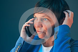 Nervous worried businesswoman during unpleasant telephone conversation photo