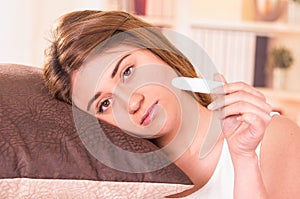 Nervous young girl holding pregnancy test
