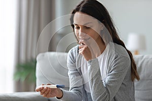 Nervous young woman waiting for pregnancy test result close up