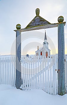 Nesseby church seen through a gate, Norway
