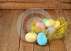 Nest of Easter Eggs on Rustic Wood