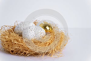 Nest with Easter eggs on white table. Selective focus