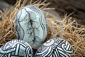 Nest with Easter eggs on the wooden background