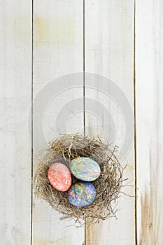 Nest with twigs and colored Easter eggs