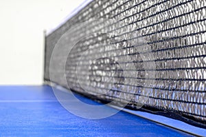 Net on a blue pingpong table close-up