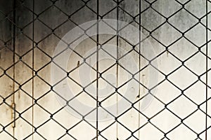 Net fence and grunge wall background