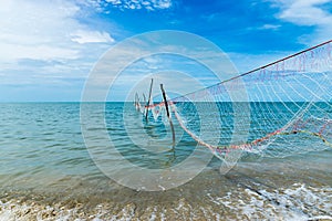 Net fishing in the ocean when the water receded photo