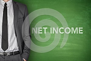 Net income text on green blackboard