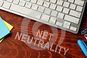 Net neutrality written on a wooden surface. photo