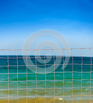 Net over blue sky and sea waves