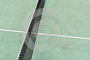 Net and a part of an outdoor rubber tennis court