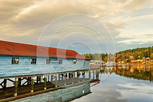 A net shed reflects in the Puget Sound at Gig Harbor